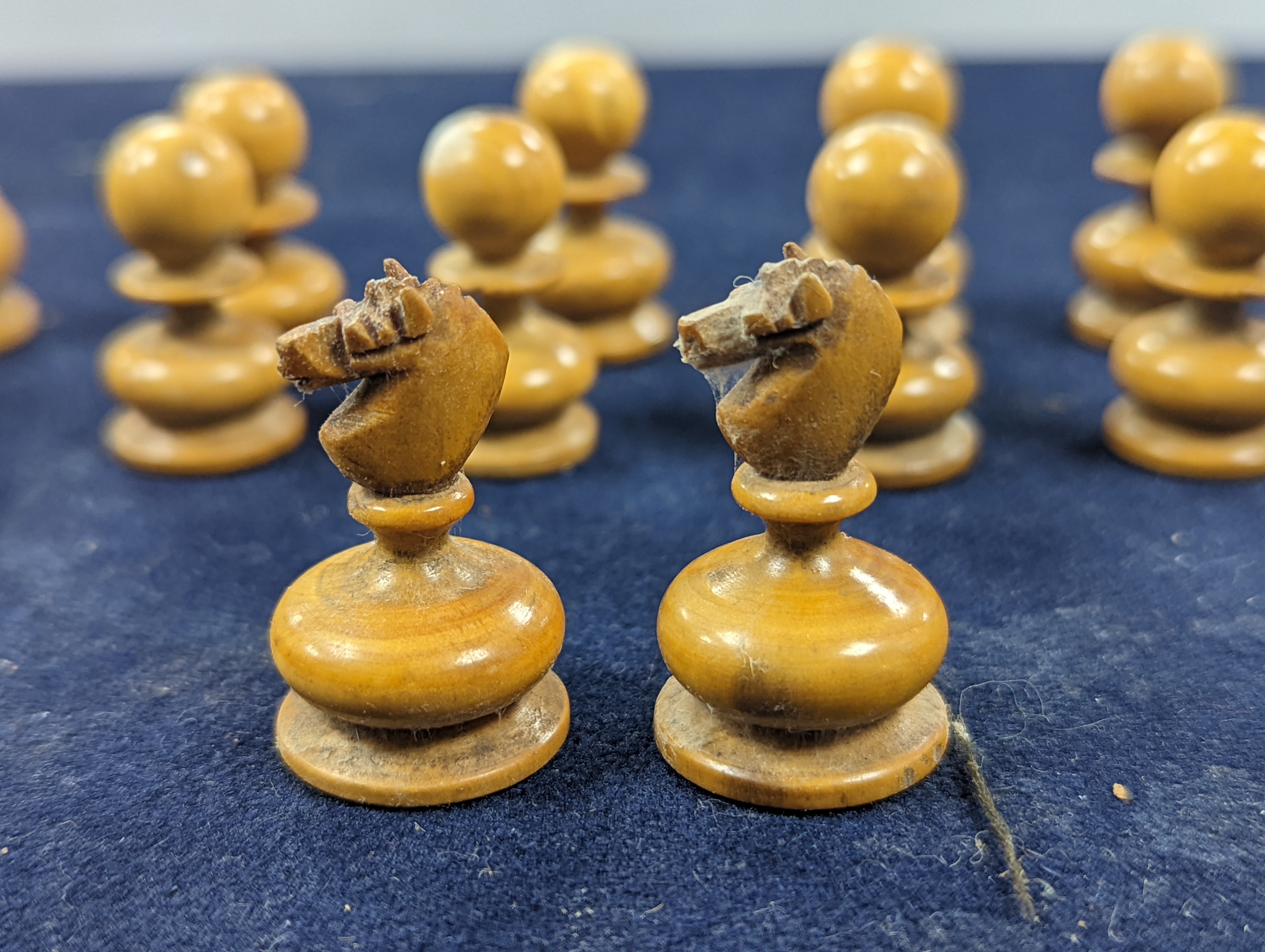 A Victorian brass inset mahogany games box, fitted with solitaire, cribbage, chessmen, draughts etc., 33cm, a turned and stained bone chess set, another games box containing chessmen and draughts